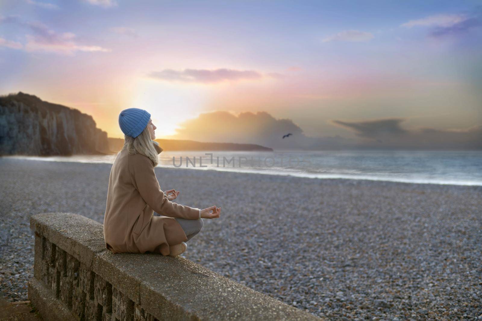 A woman doing yoga at the beach