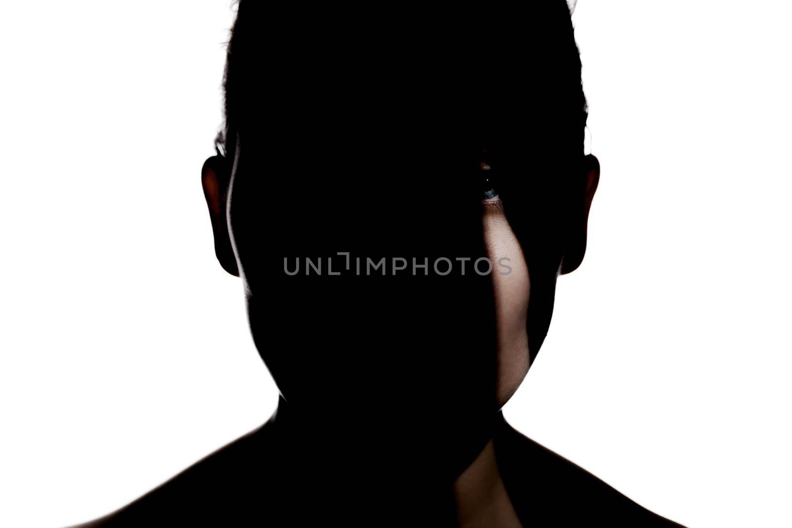 Fashionable studio portrait of a cute girl. Silhouette of a beautiful young woman with hard shadows on her face. against white backgroung by kokimk