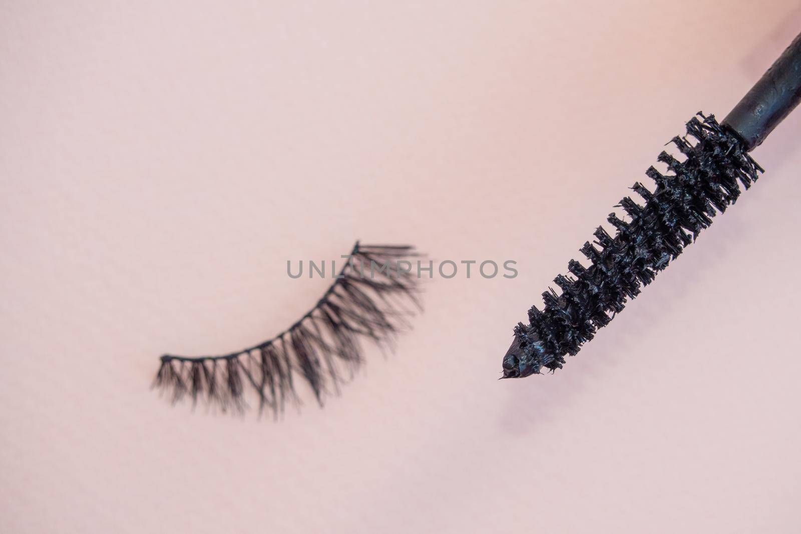 Fake eyelashes on pastel pink background. Beauty concept. Makeup cosmetics. Top view, flat lay. Layout. Place for text and design. Web Banner. Minimal style by Andre1ns