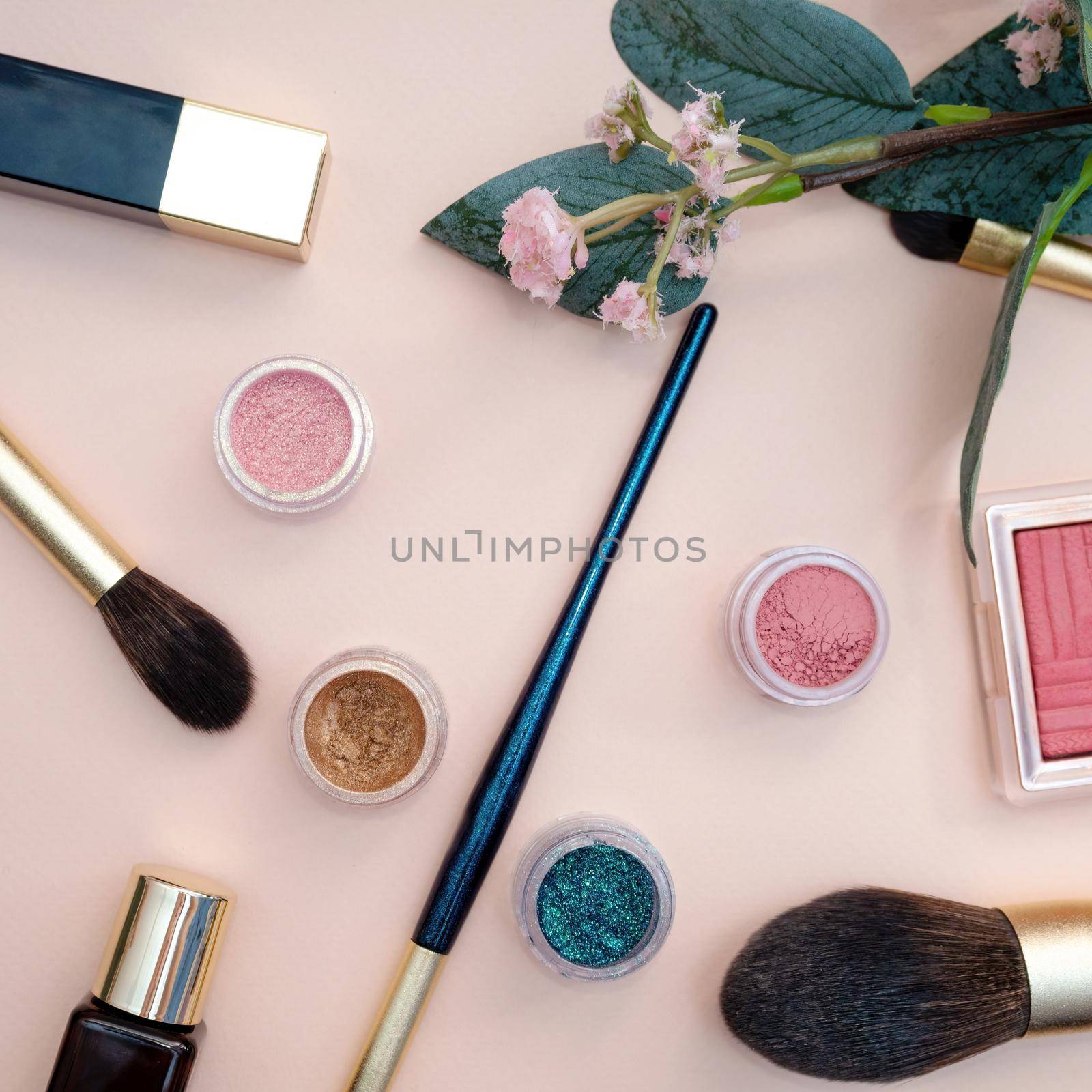 set of beauty cosmetics for female face and eye makeup on pink background . photo