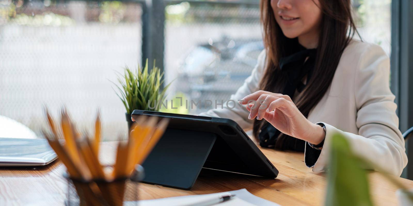 A businesswoman completes KYC using an online banking program in order to open a digital savings account. The definition of cyber security.