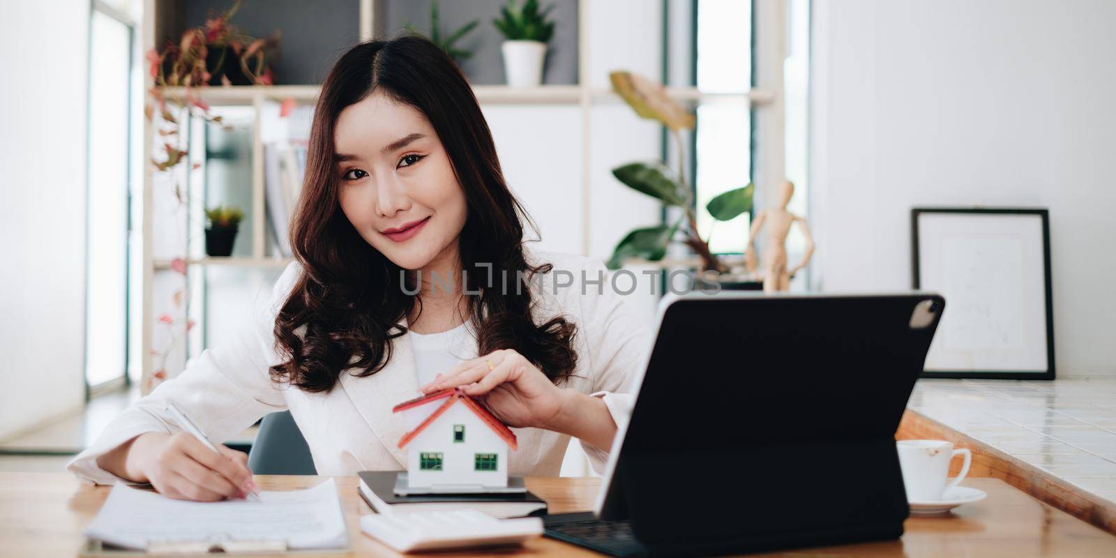 Business woman or broker checking contract agreement paper with customer to sign contract. Real Estate and Agreement concept. by itchaznong