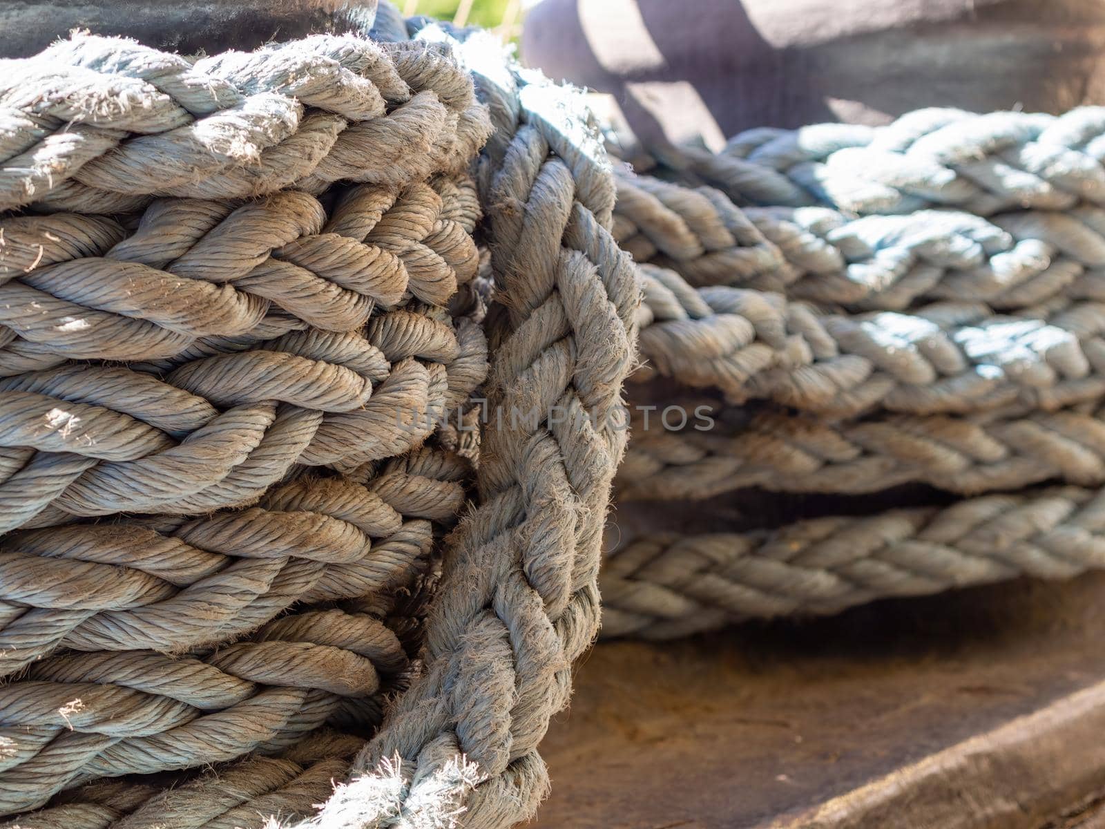 Close-up of an old frayed boat rope as a nautical background. by Andre1ns