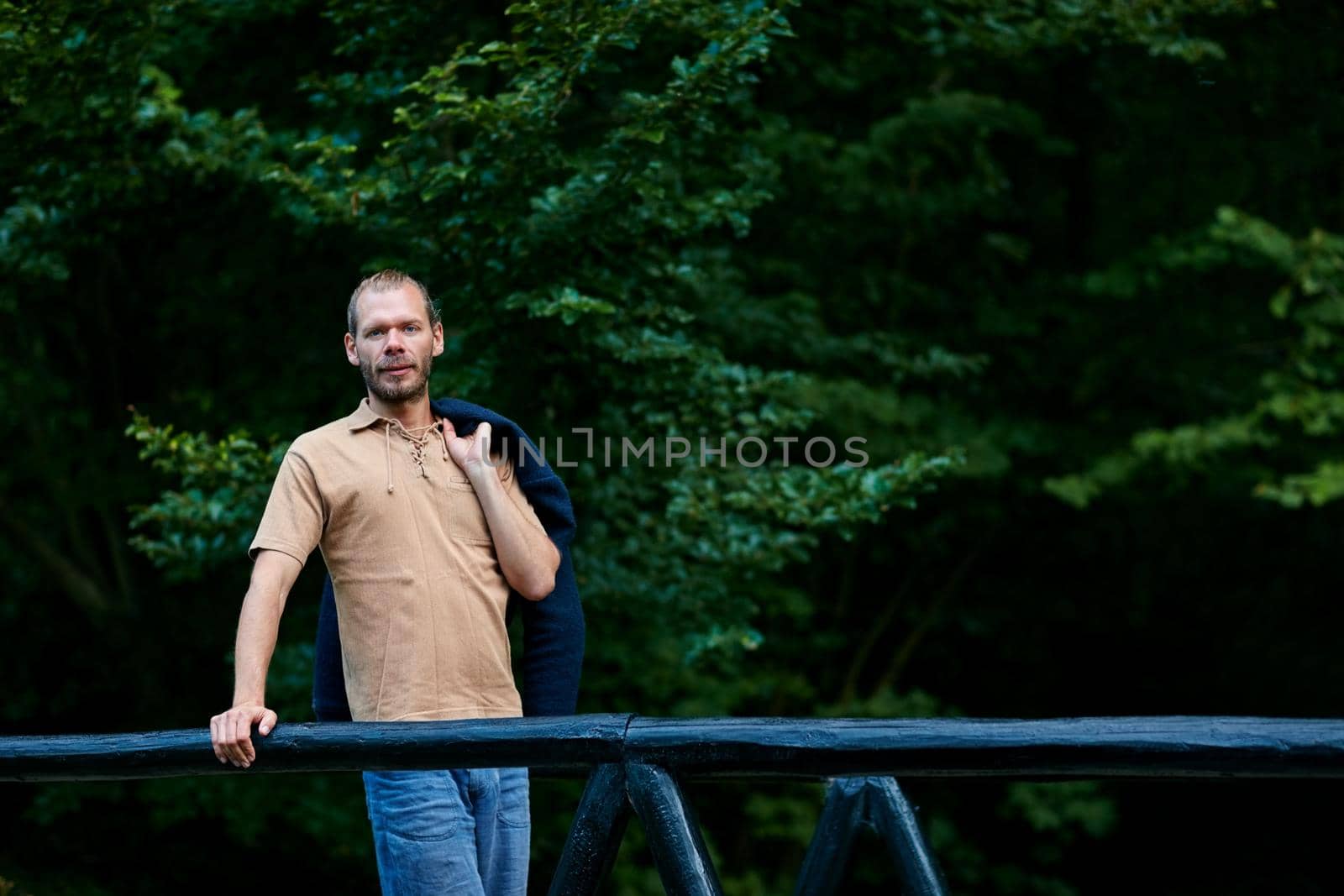 I come here for the view. Portrait of a handsome man standing outdoors. by YuriArcurs
