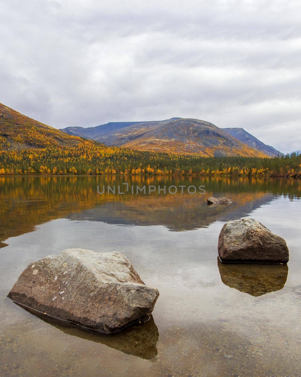 Lake with turquoise water in the mountains in autumn on a cloudy day. view from above by Andre1ns