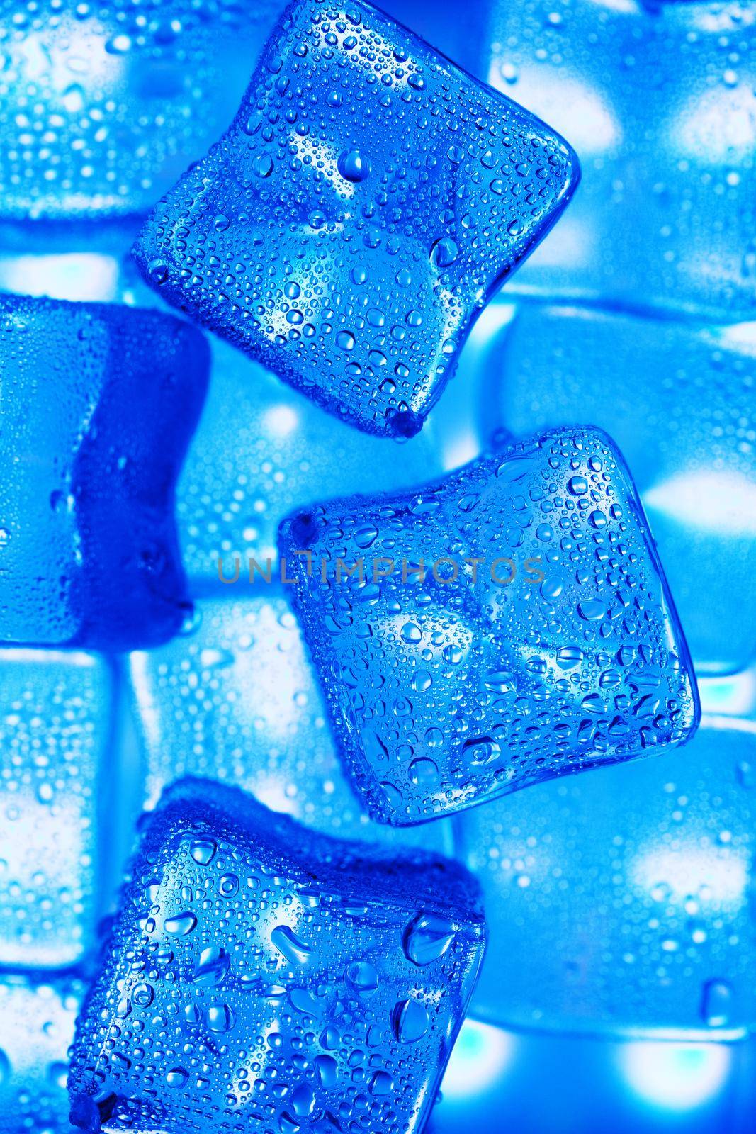 Ice cubes with blue backlight in the freezer close-up in full screen by AlexGrec