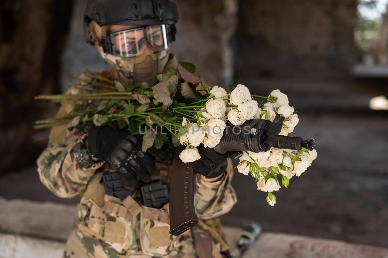 Caucasian woman in military uniform holding a machine gun and a bouquet of white roses. by mrwed54