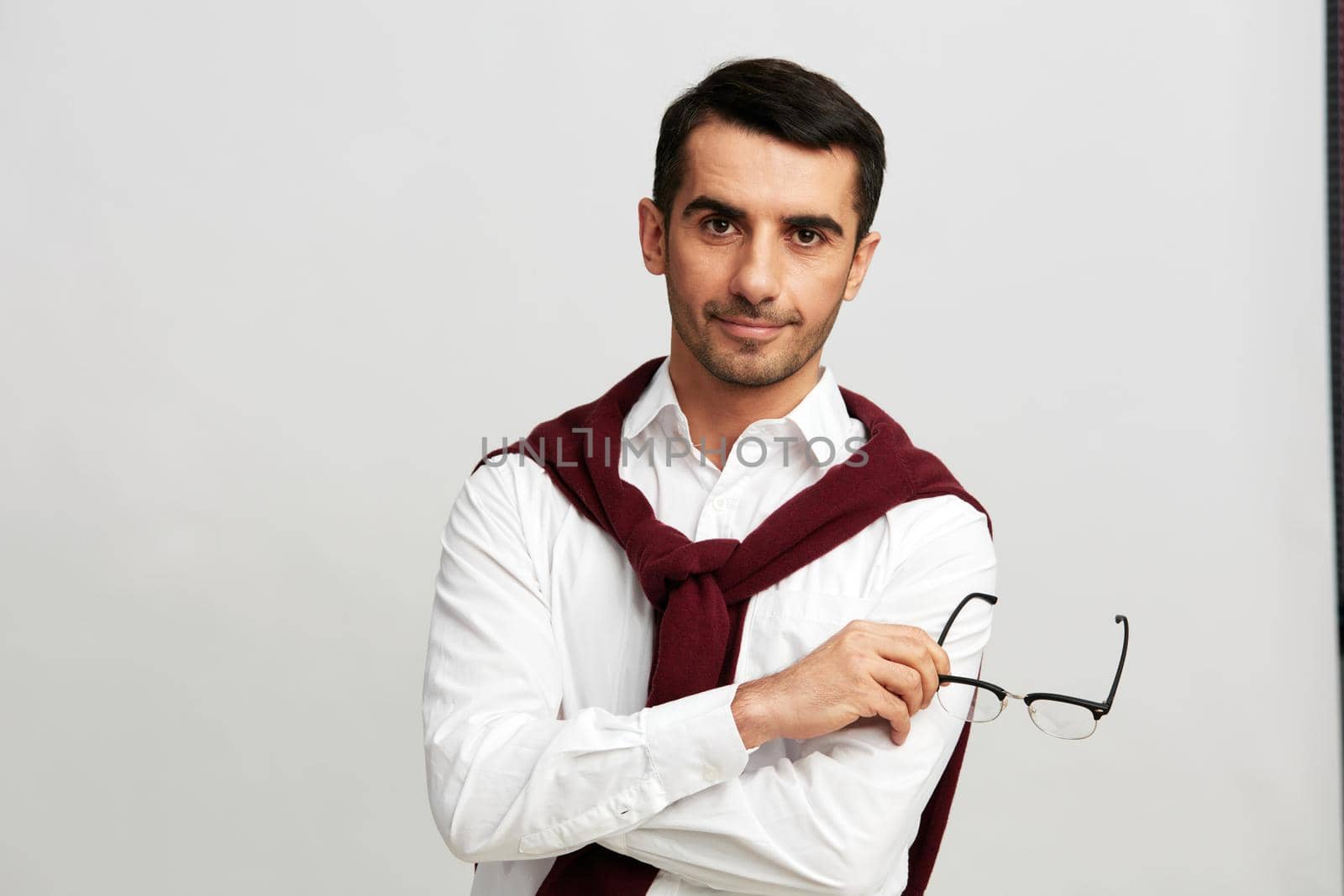 businessman portrait red sweater on shoulders glasses lifestyle business and office concept. High quality photo