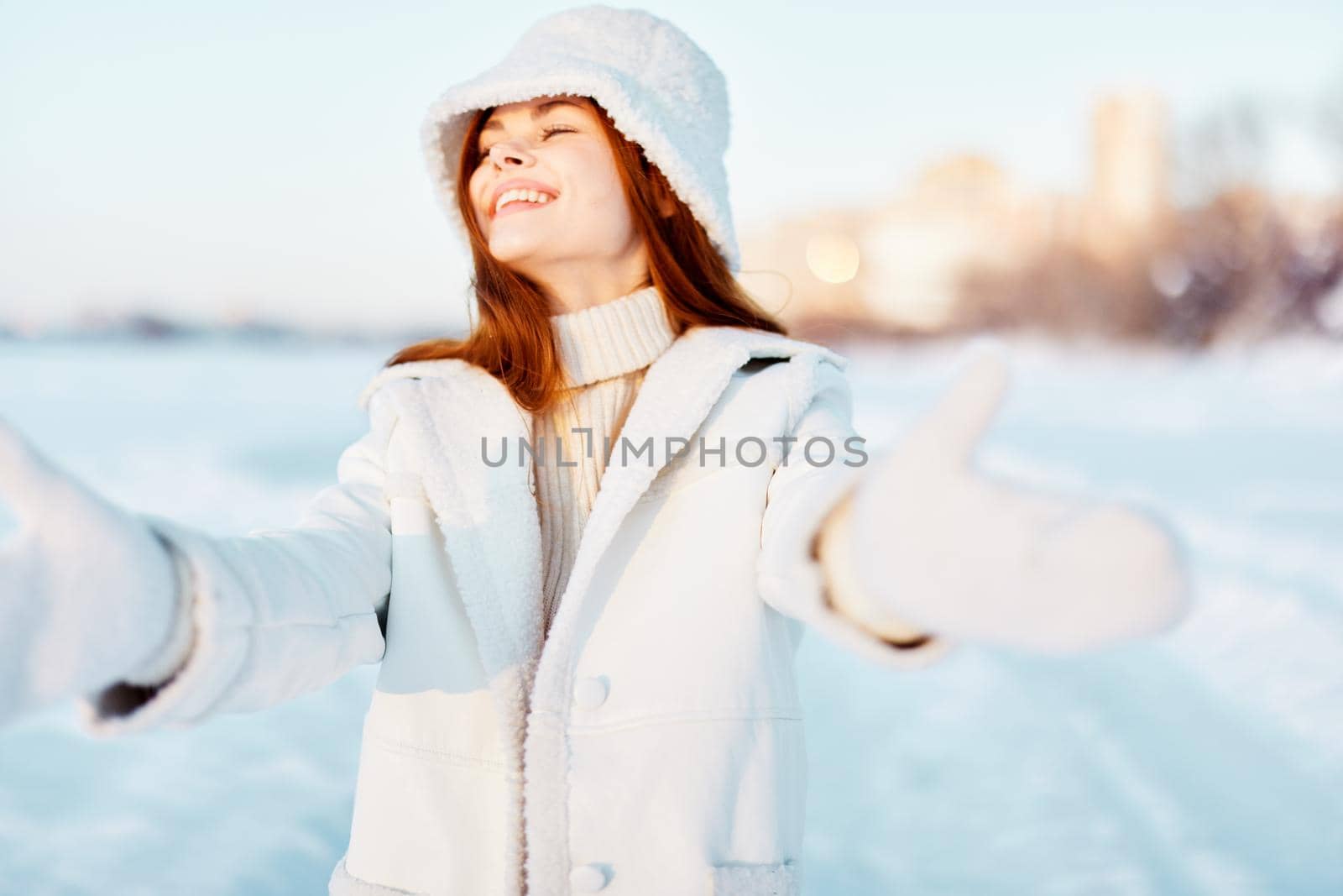 woman in a white coat in a hat winter landscape walk nature. High quality photo