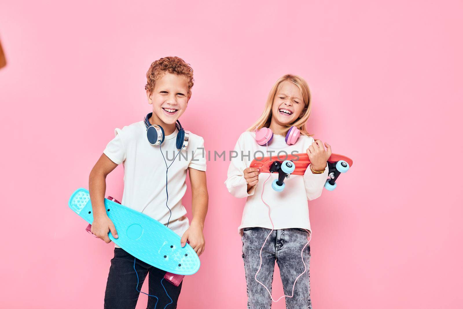 Children riding skateboard are playing together isolated background by SHOTPRIME