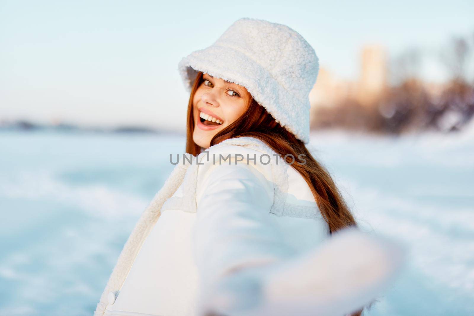 young woman in a white coat in a hat winter landscape walk travel by SHOTPRIME