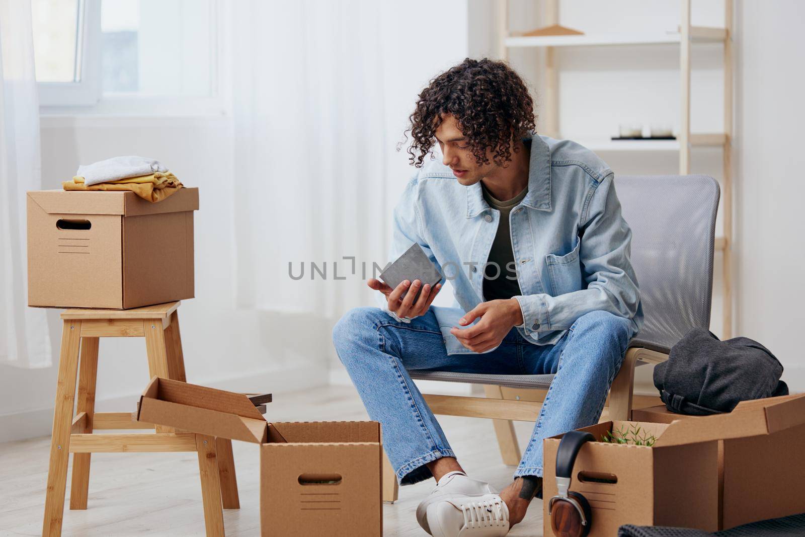 portrait of a man cardboard boxes in the room unpacking Lifestyle. High quality photo