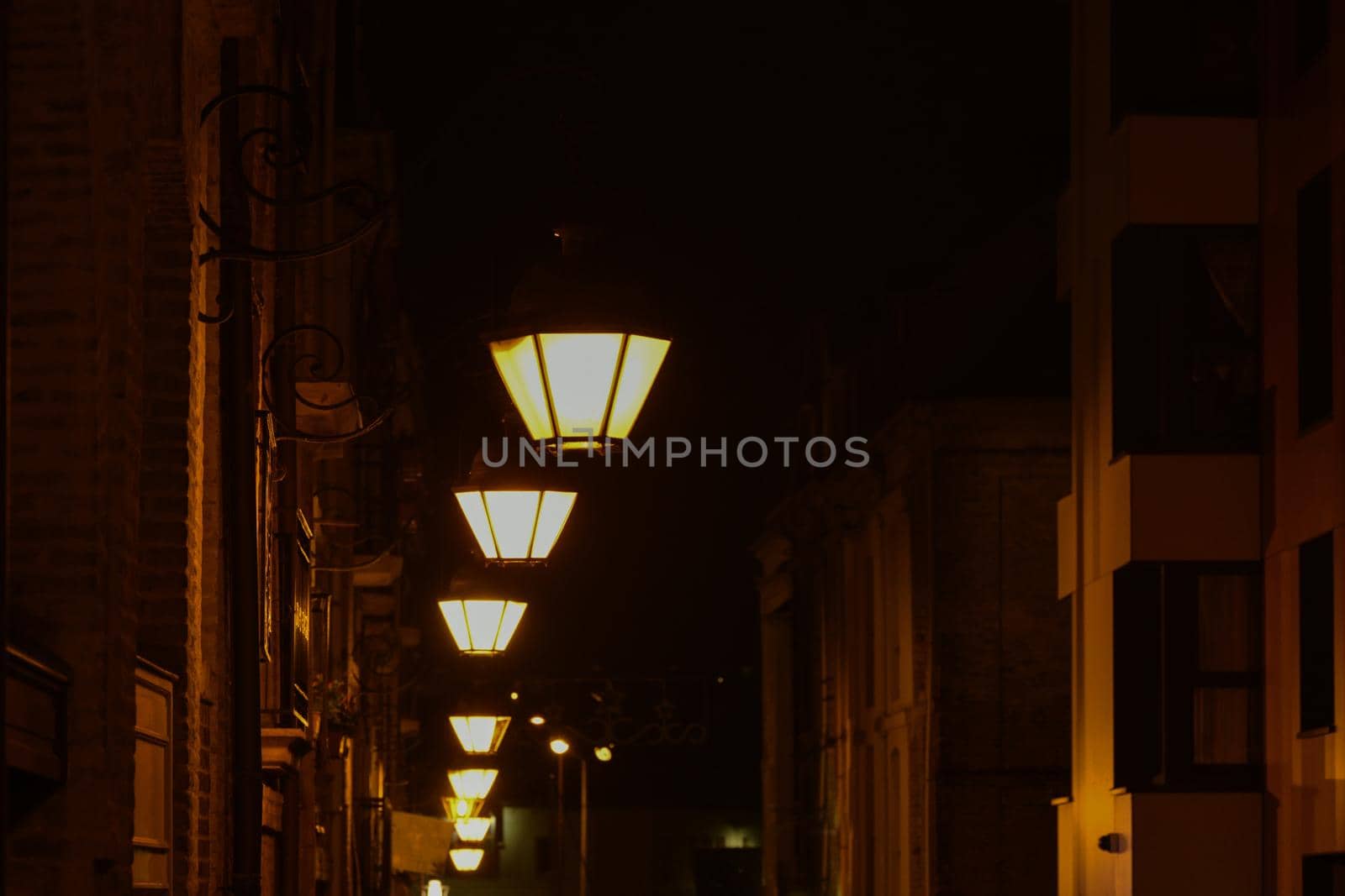 The vintage lamps shine on the street at night by Godi