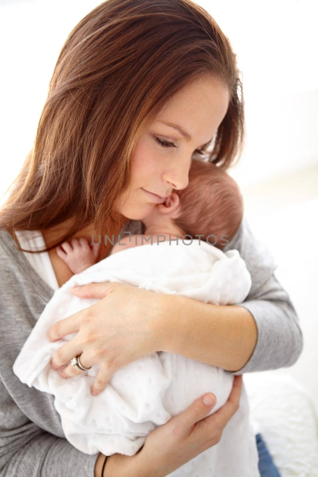 Shot of a young mother holding her newborn baby girl in her arms.