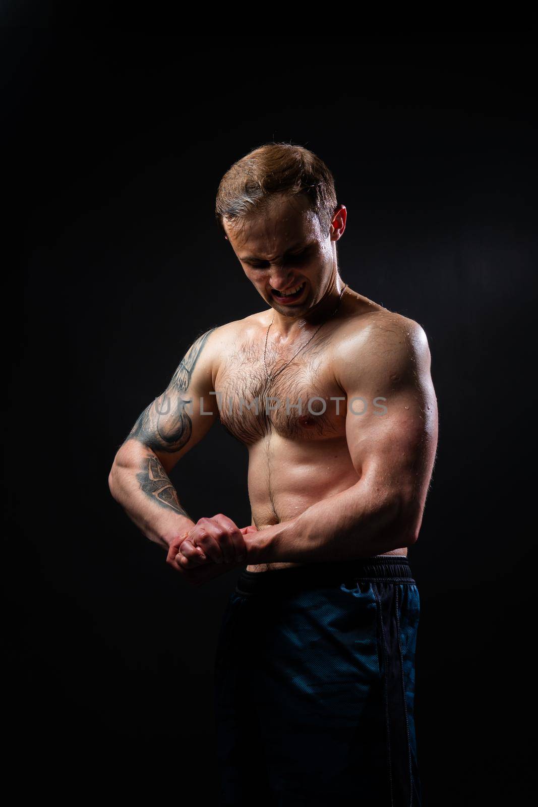 Man on black background keeps dumbbells pumped up in fitness muscle sexy torso, arm muscular fitness hold heavy, male lifestyle. Lift metal, gym fit