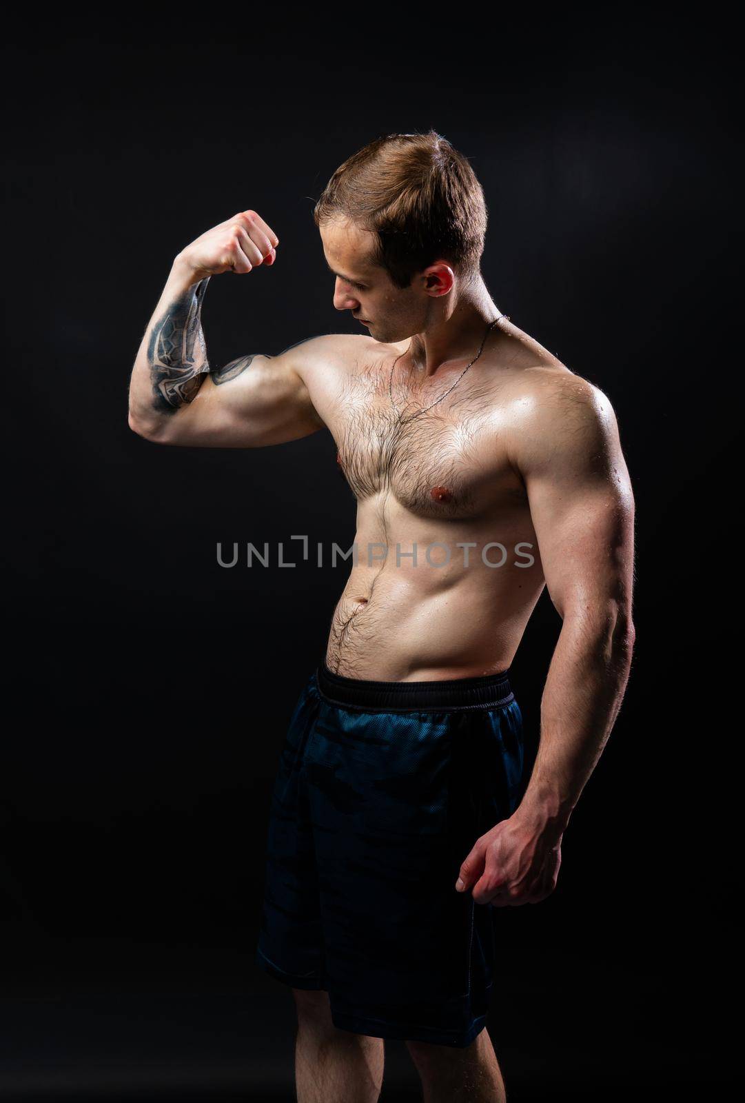Man on black background keeps dumbbells pumped up in fitness chest sport, training exercise bodybuilder hand, Attractive handsome guy fit