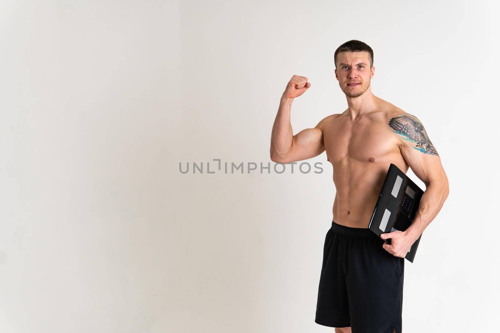 Man with weights health pondered, health and sports on a white background ache painful, cramp sick male stress, hand expression. Touching care, problem suffer attractive