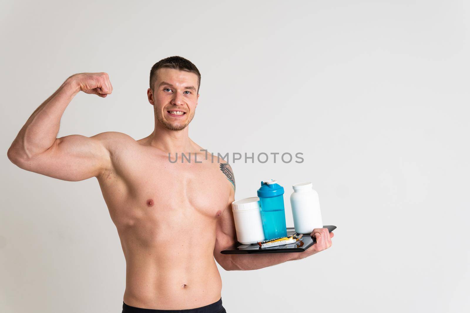 Fitness protein jars white on white background bodybuilder powder strong high pain hurt muscle, cramp person caucasian health muscular expression. Touching red sickness, problem suffer attractive