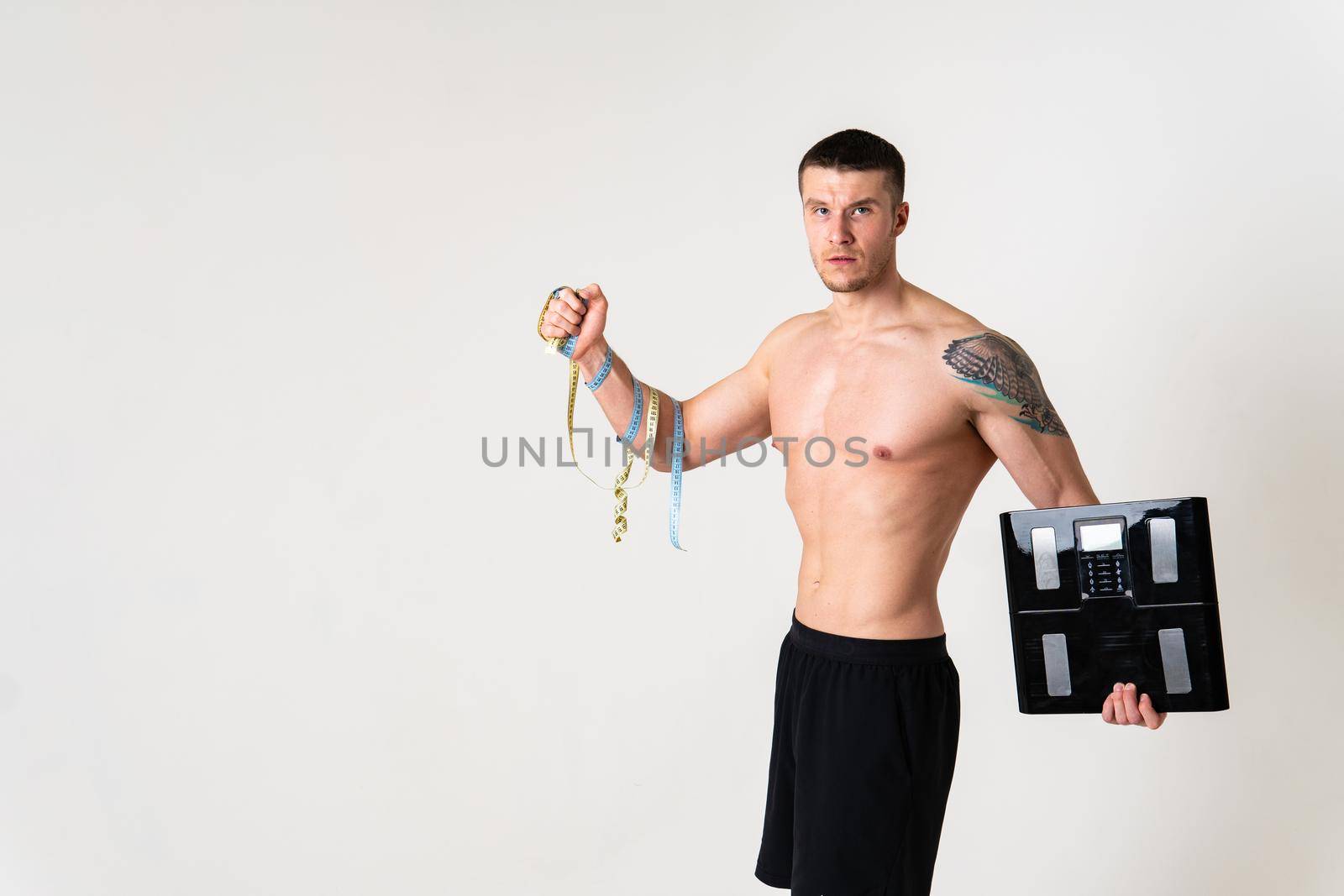 Man with weights health pondered, health and sports on a white background ache sore muscle, backache spine white young medical, expression. sickness, lower suffer attractive