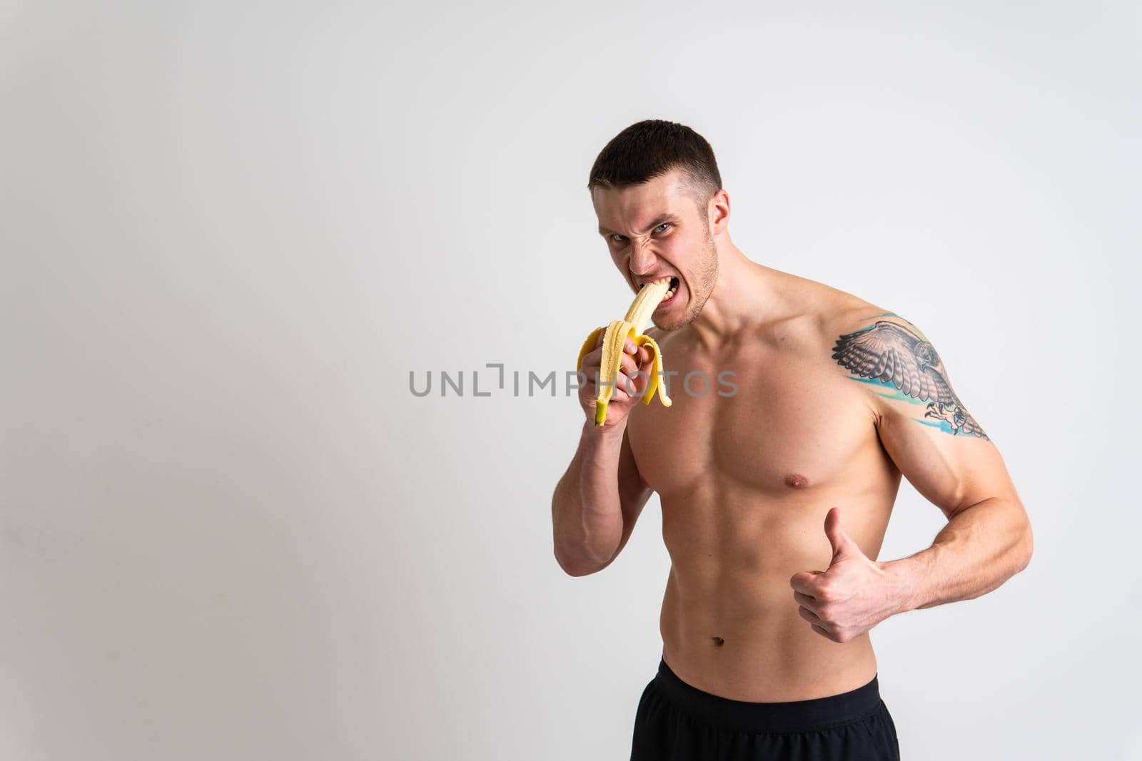 Man holds apples in fitness white background isolated fit health, handsome fruit model background, caucasian studio. strength red, bodybuilder chest