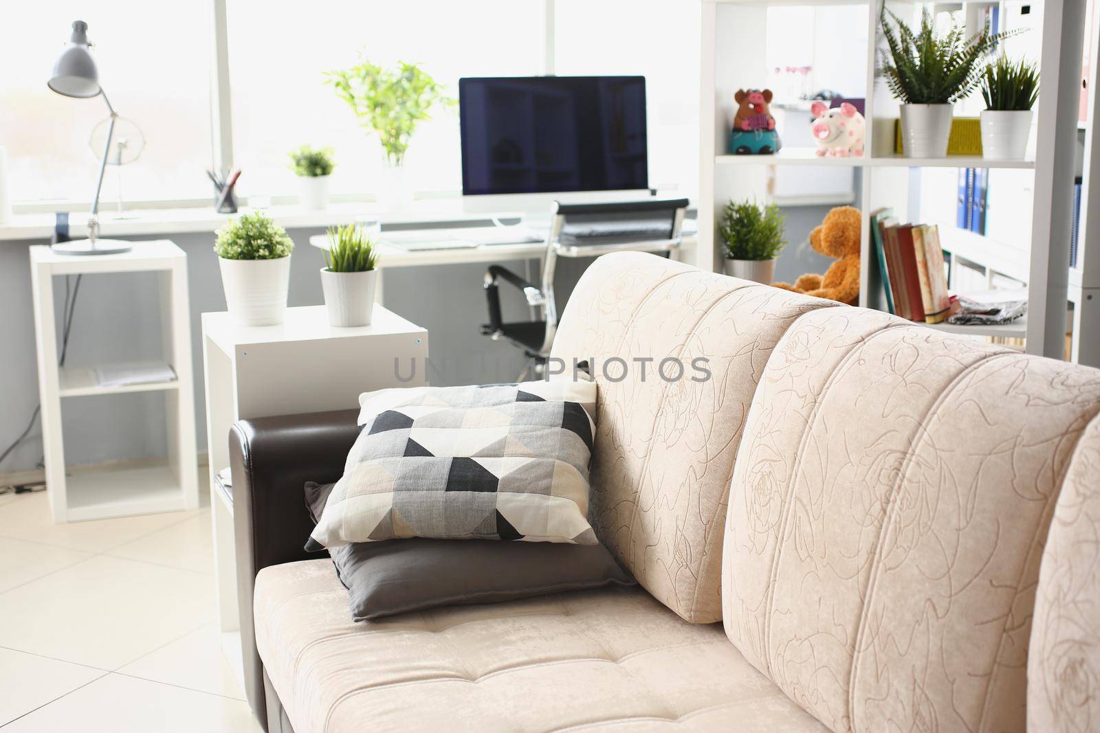Close-up of cozy home interior, sofa with working place and laptop, fresh renovation. Empty living room, cleaned up space. Living place, design concept