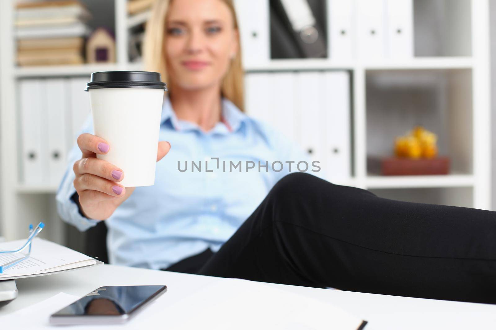 Portrait of blonde female lift hot cup of coffee drink, pause from work, cheers. Coffee break, lunch, relax, need energy, business, office life concept