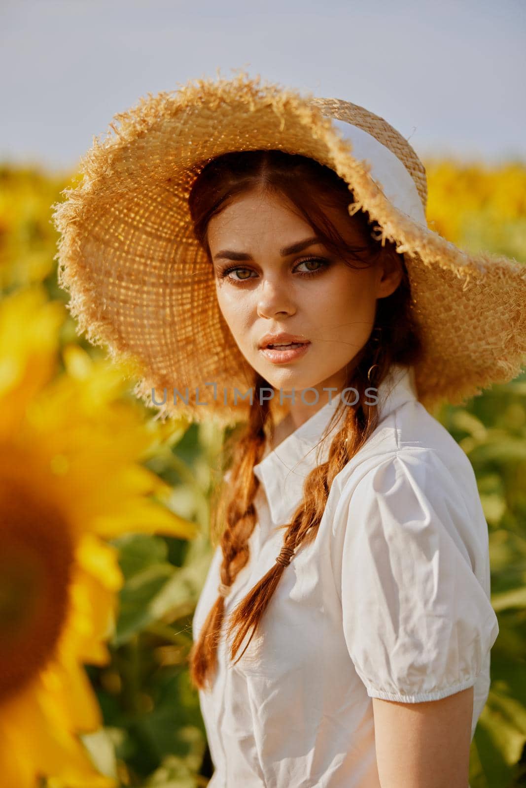 woman with pigtails in a field of sunflowers lifestyle landscape by SHOTPRIME