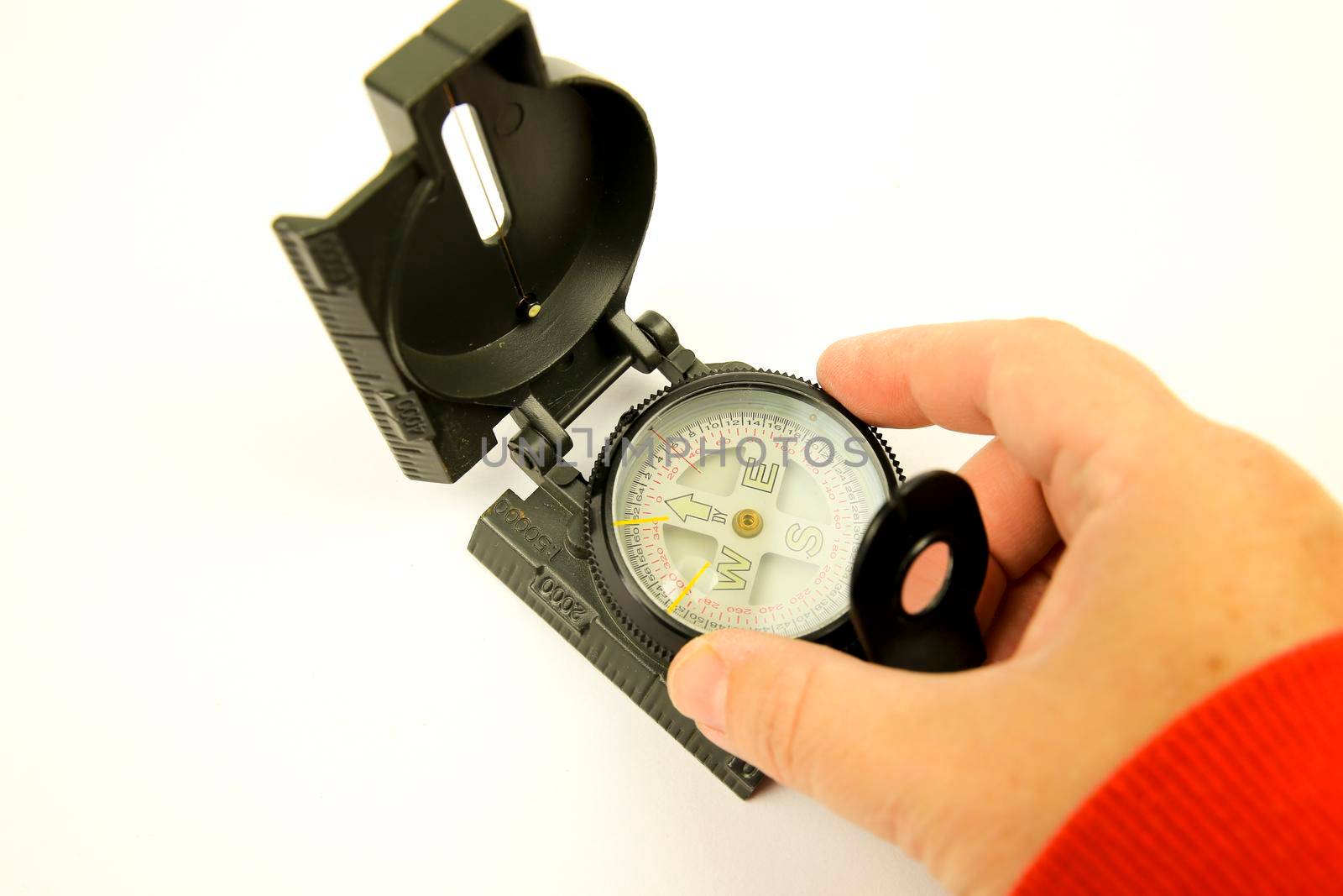 Hand holding a Military green compass on white background