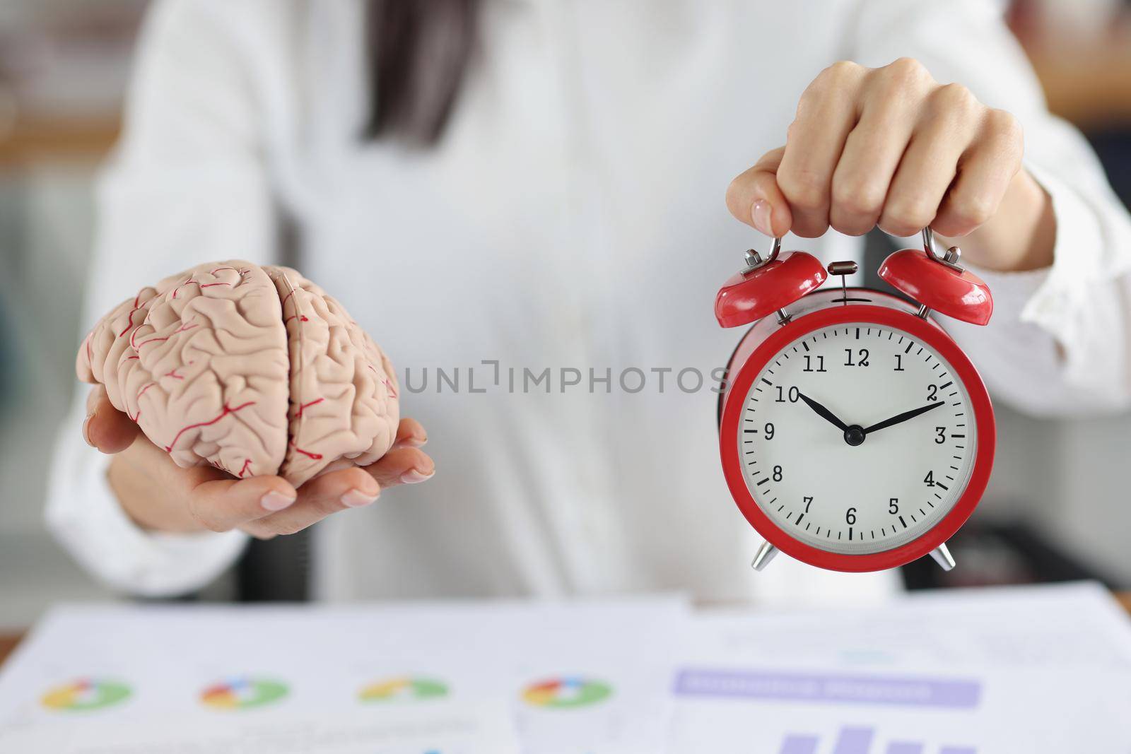 Close-up of female hold clock and brain miniature, work in progress, time to think. Creativity, smart, idea, startup, timing, business, brainstorm concept