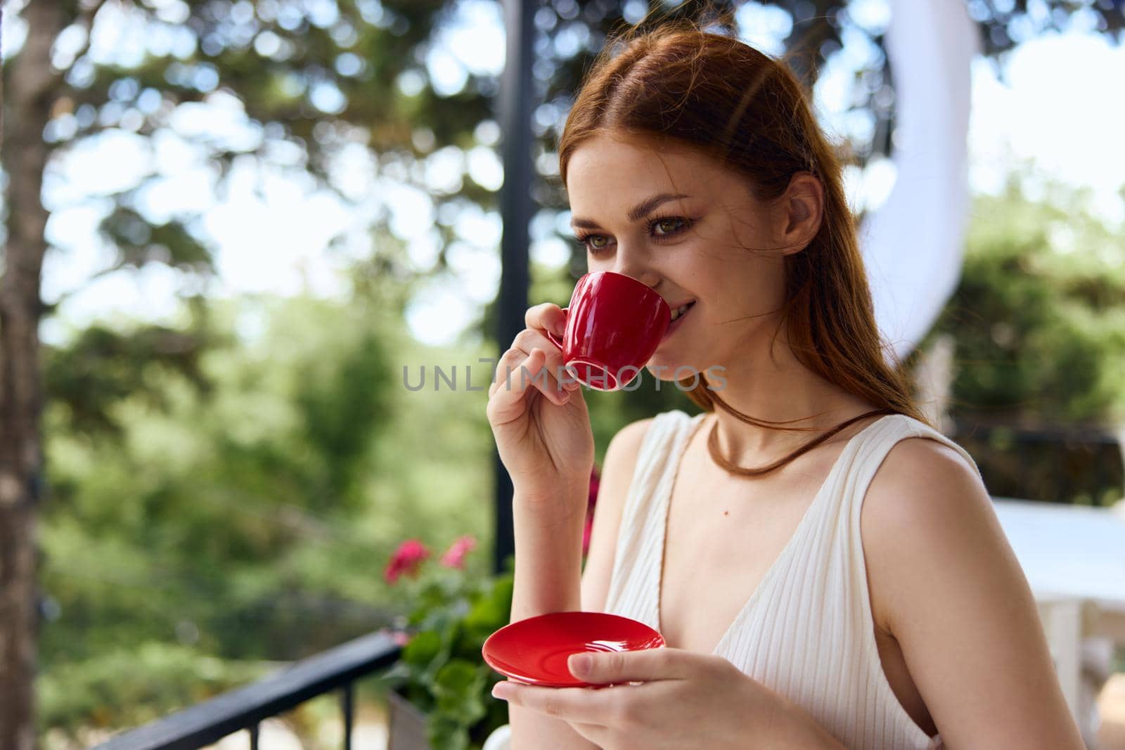 Young stylish woman drinking coffee outdoors unaltered by SHOTPRIME