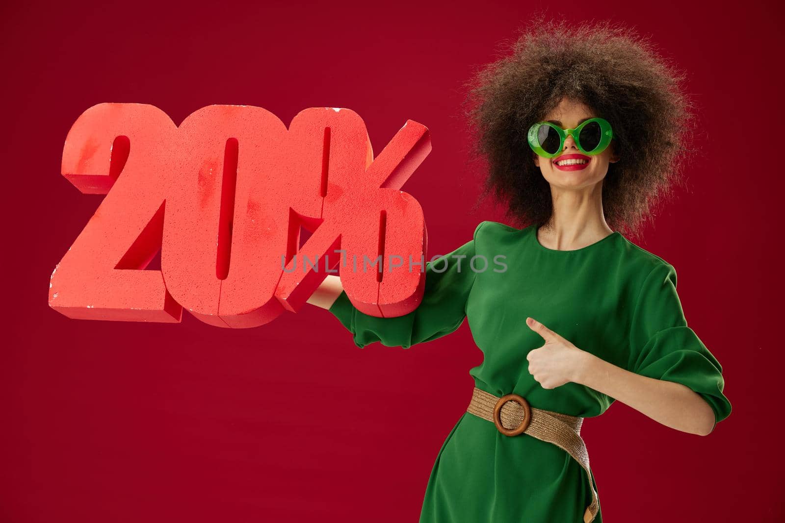 pretty woman holding red twenty percent discount advertising red background unaltered by SHOTPRIME