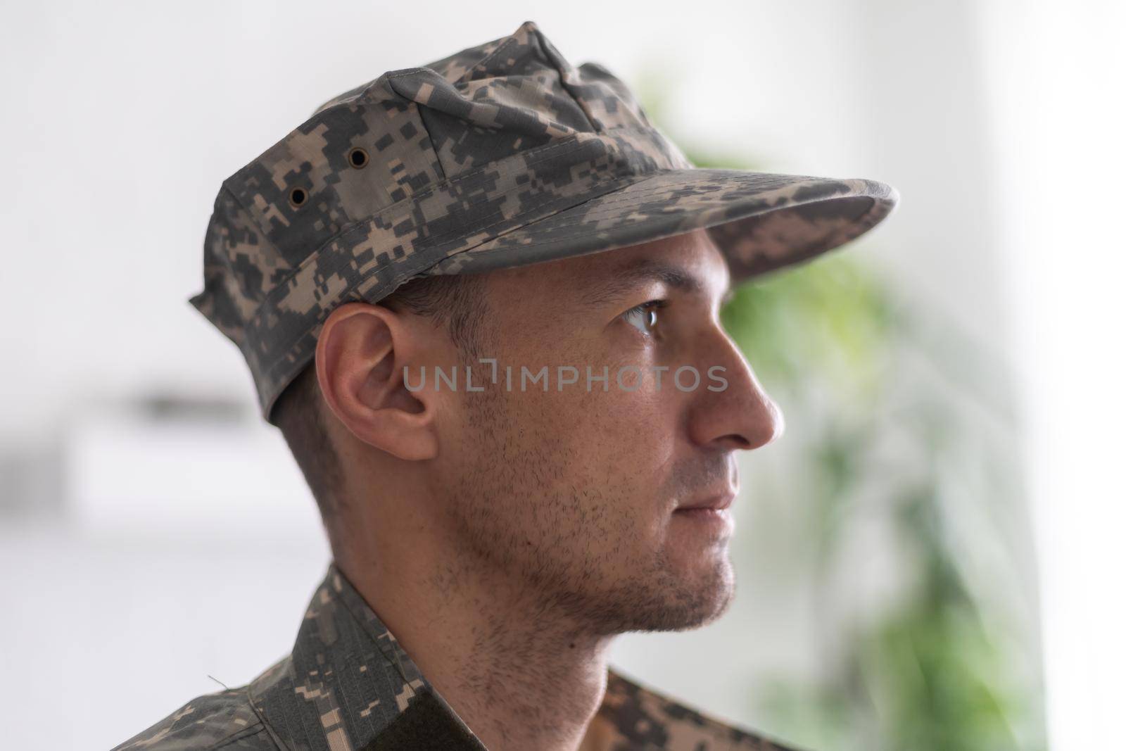 Photo of soldier in camouflaged uniform close-up view