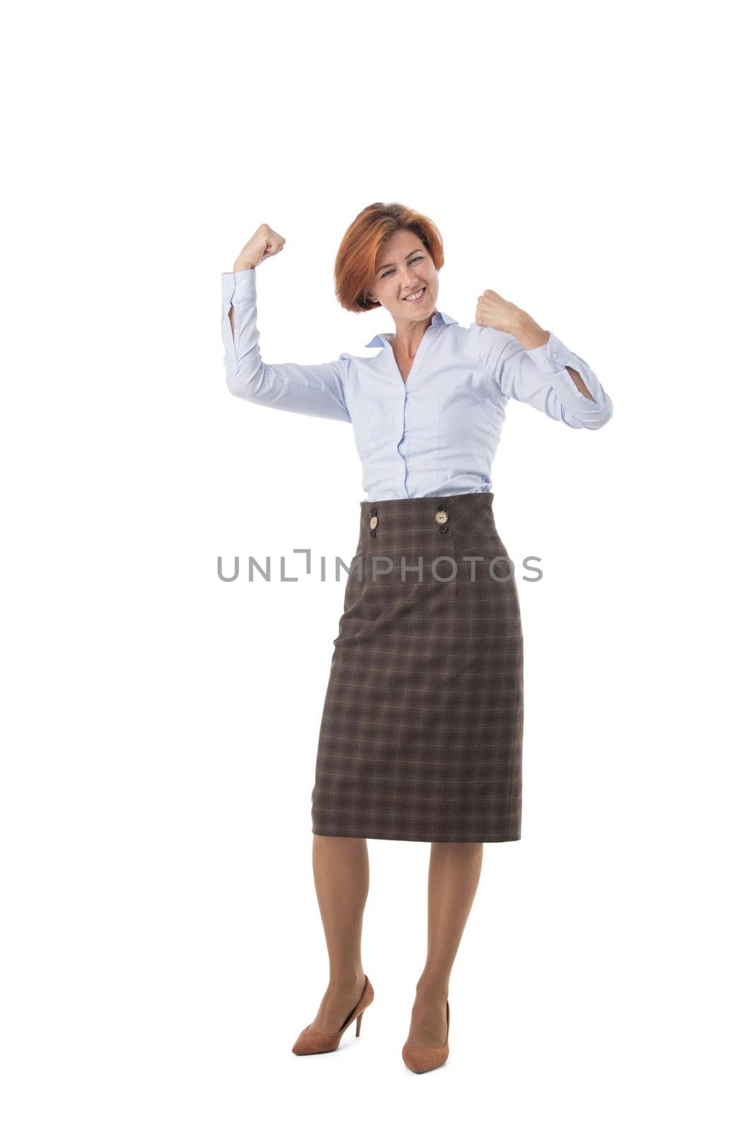 Full length portrait of happy business woman holding fists isolated on white background