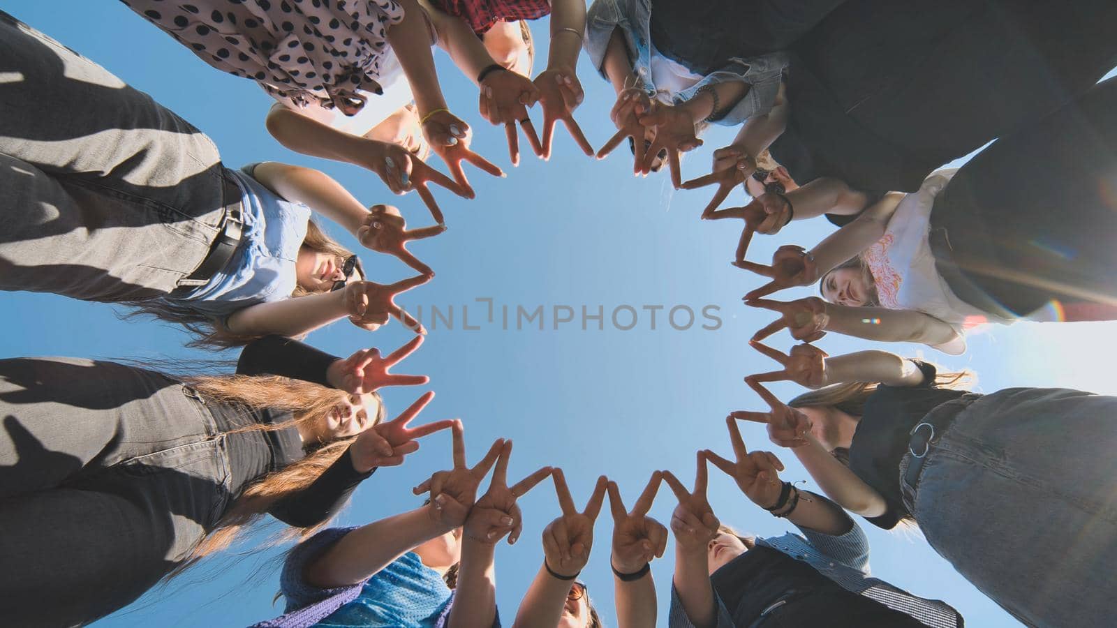 A group of girls makes a circle from their fingers