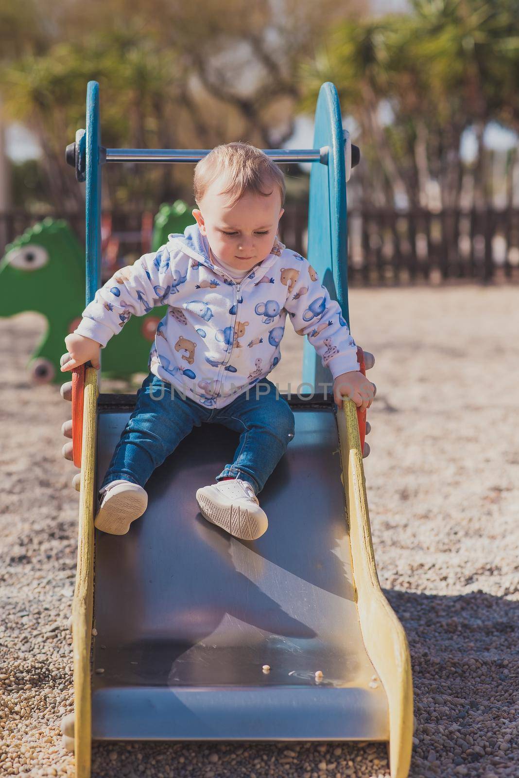 happy boy playing in playground by jcdiazhidalgo
