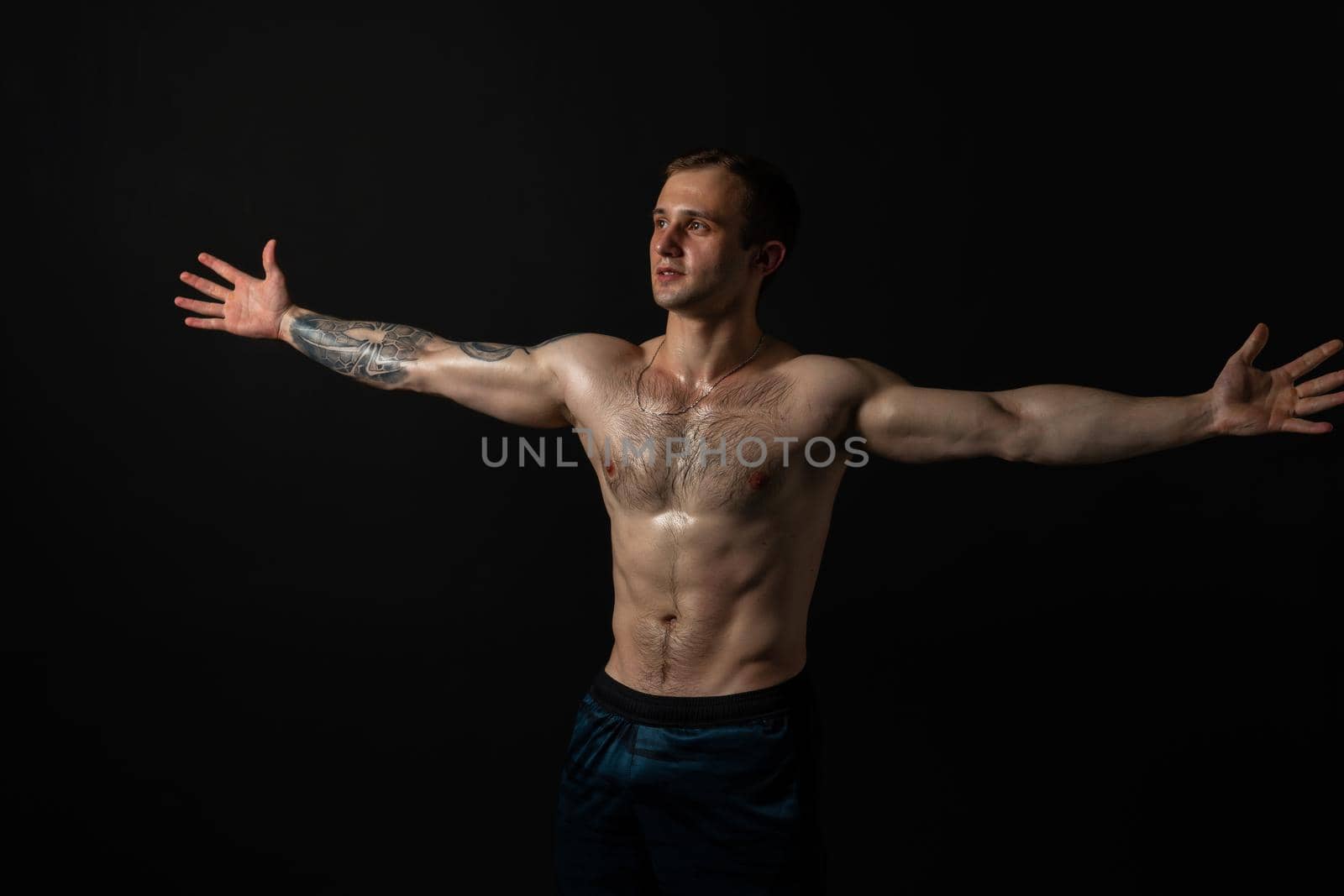 Man on black background keeps dumbbells pumped up in fitness bodybuilding sexy torso, athlete workout lifting heavy, weightlifting. Lift skin power, gym fit