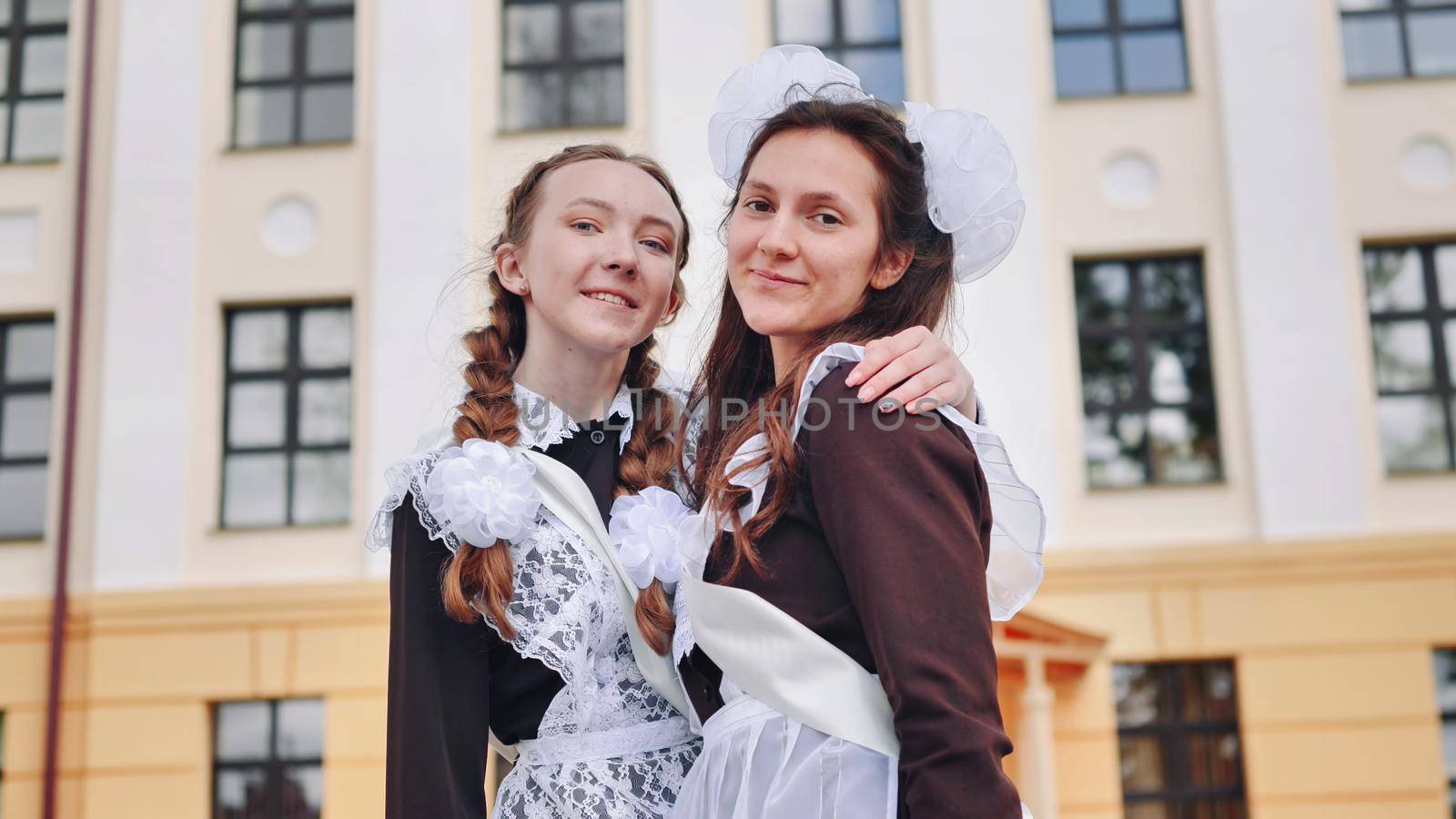 Two russian female graduates pose on their graduation day
