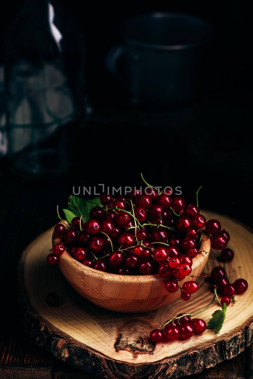 Fresh picked red currants in wooden bowl