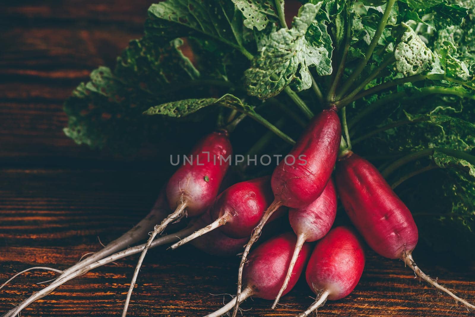 Bunch of fresh red radish on wooden table