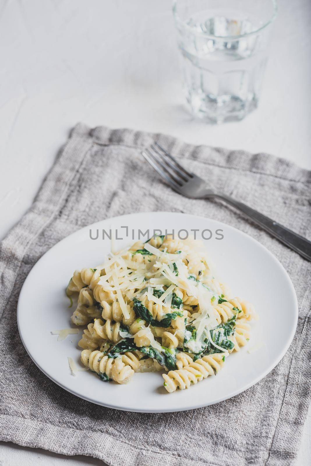 Creamy Spinach Pasta with Ricotta and Parmesan on White Plate