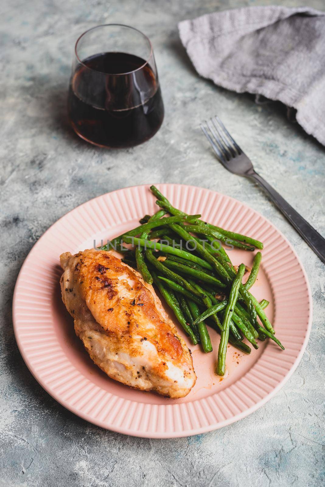 Crispy Chicken Breast Served with Green Beans on Plate by Seva_blsv