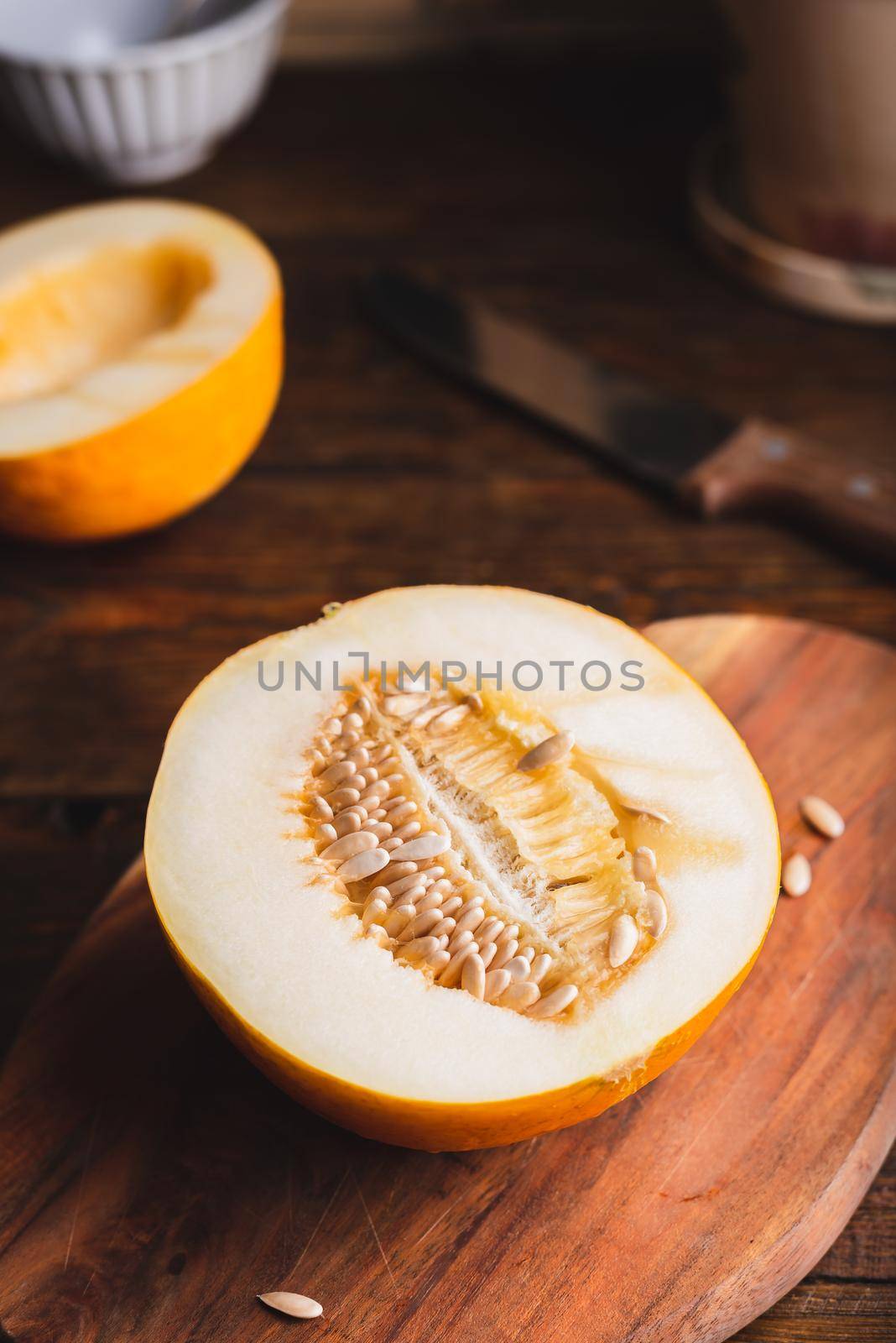 Half of Sweet Yellow Melon on Cutting Board