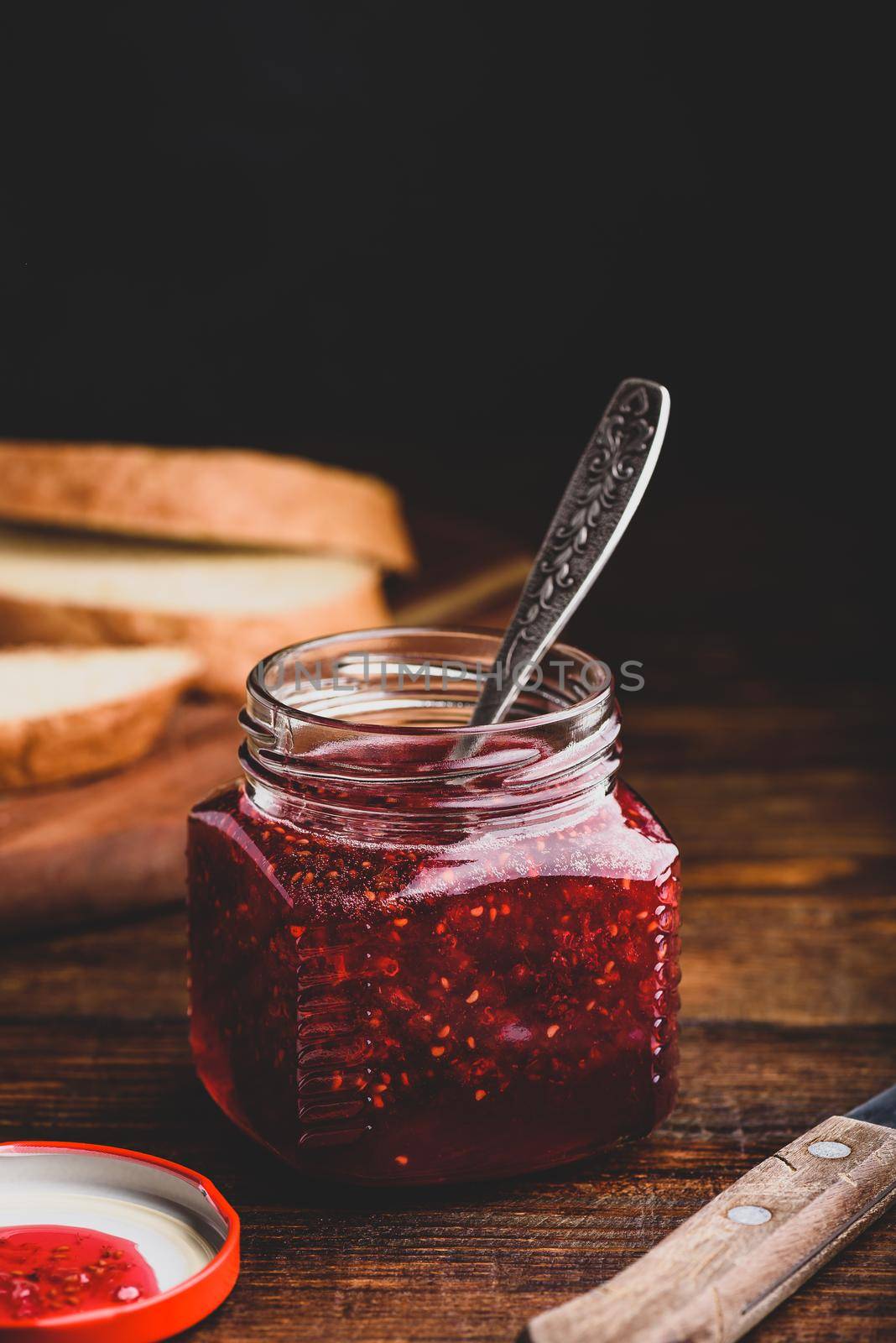 Jar of homemade raspberry jam. Toasts for breakfast.