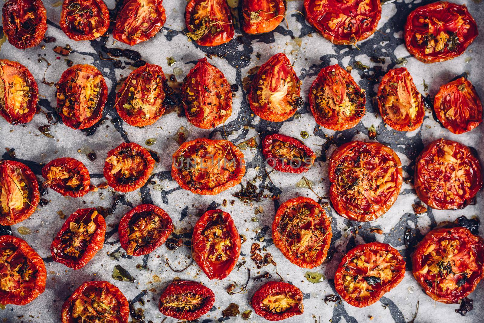 Prepared Sun Dried Tomatoes with Herbs on Parchment Paper by Seva_blsv