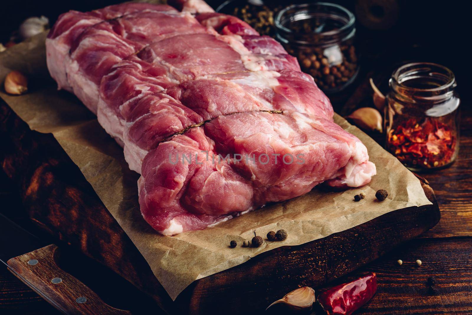 Raw pork loin joint on cutting board by Seva_blsv