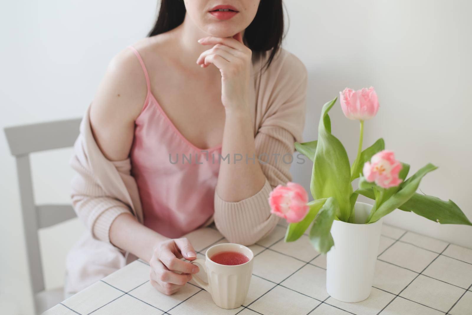 romantic tender portrait of a young woman with pink fresh tulips