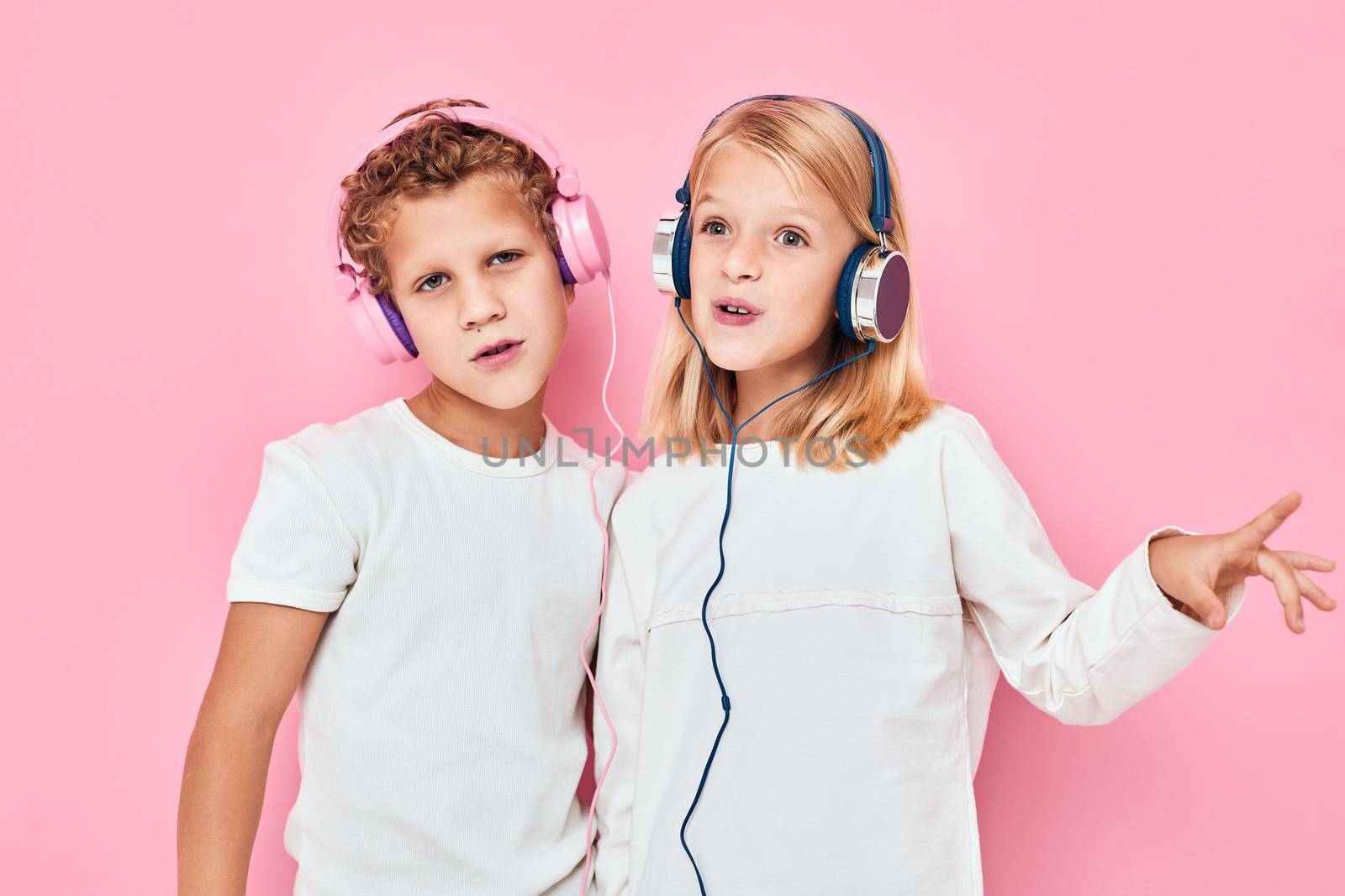 Active young people stand next to in headphones lifestyle childhood. High quality photo