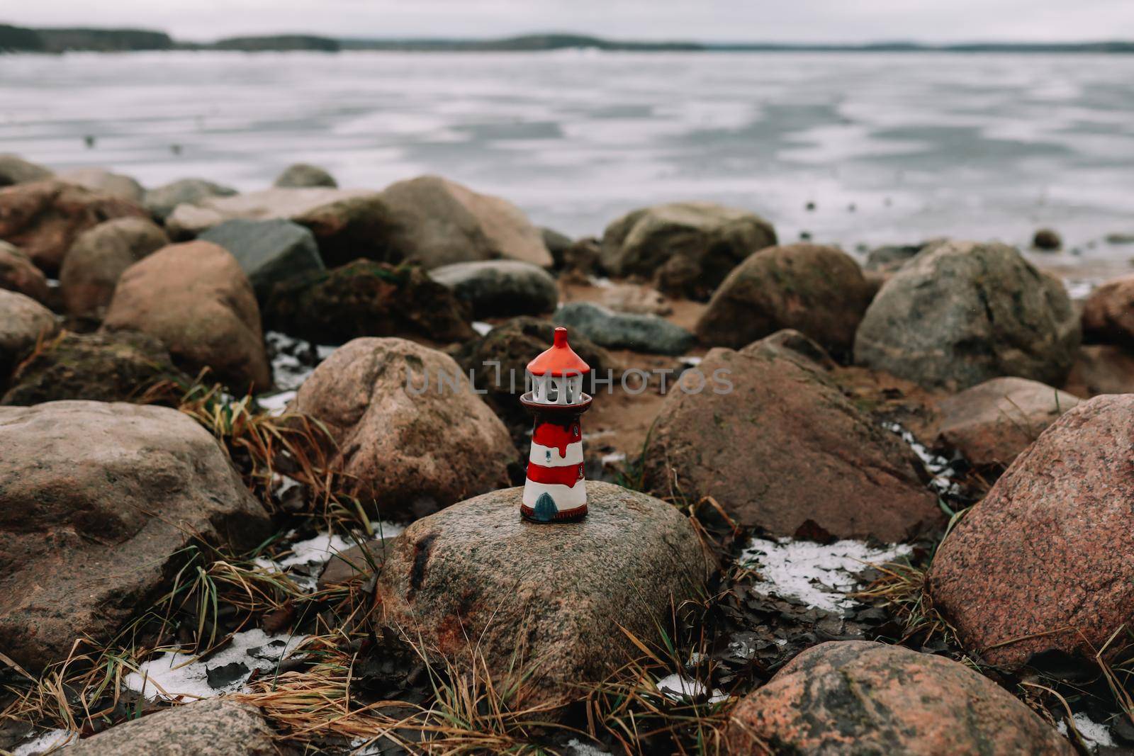 Frozen winter sea with decorative lighthouse. Nautical lifestyle. Winter, Sea, Travel, adventure, holidays and vacation concept. Travel in 2021.