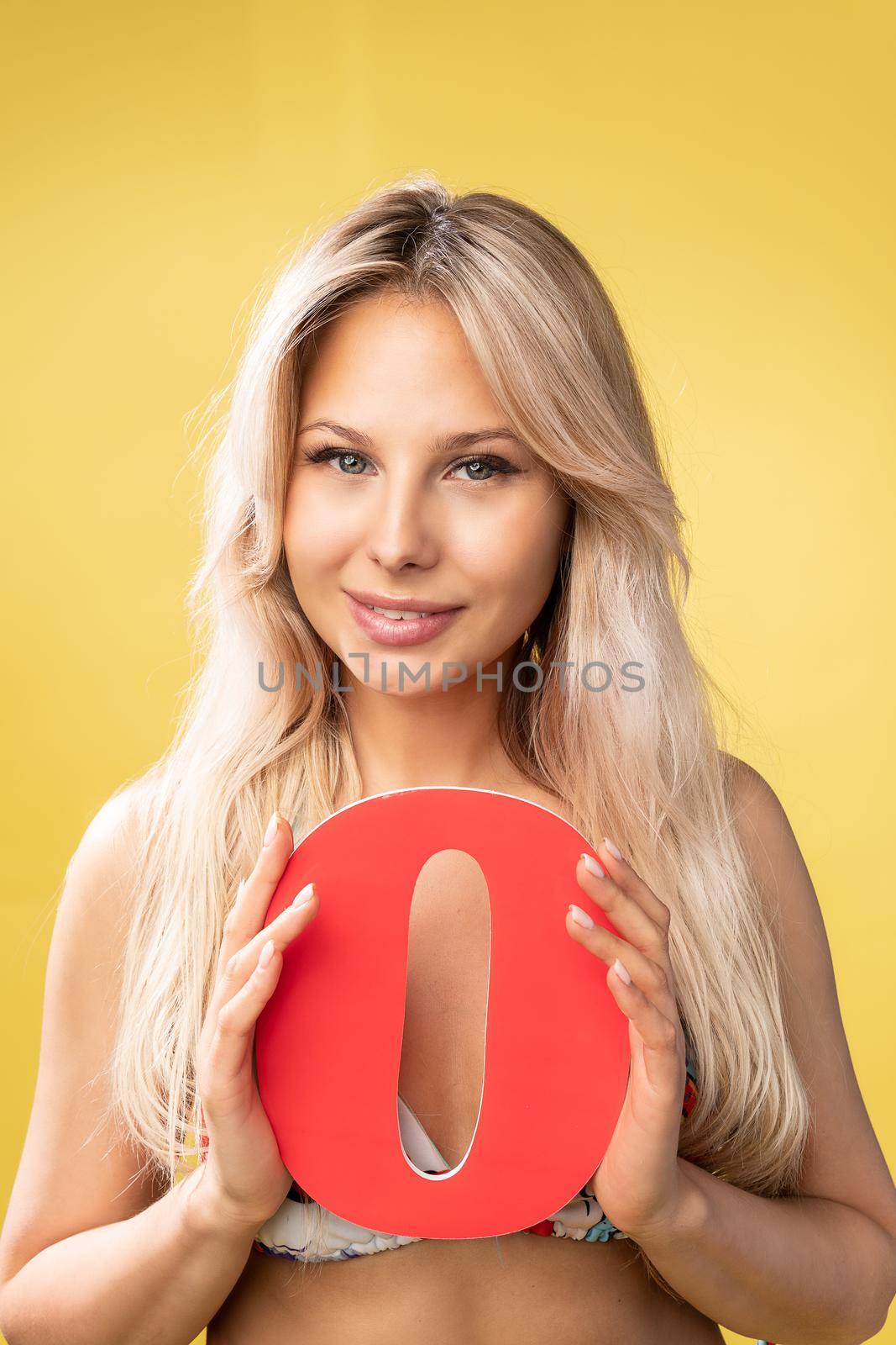 Girl holds the letters of the alphabet word love on a yellow background blonde beautiful smiles yellow people school study, cheerful green. Color child gray elementary woman