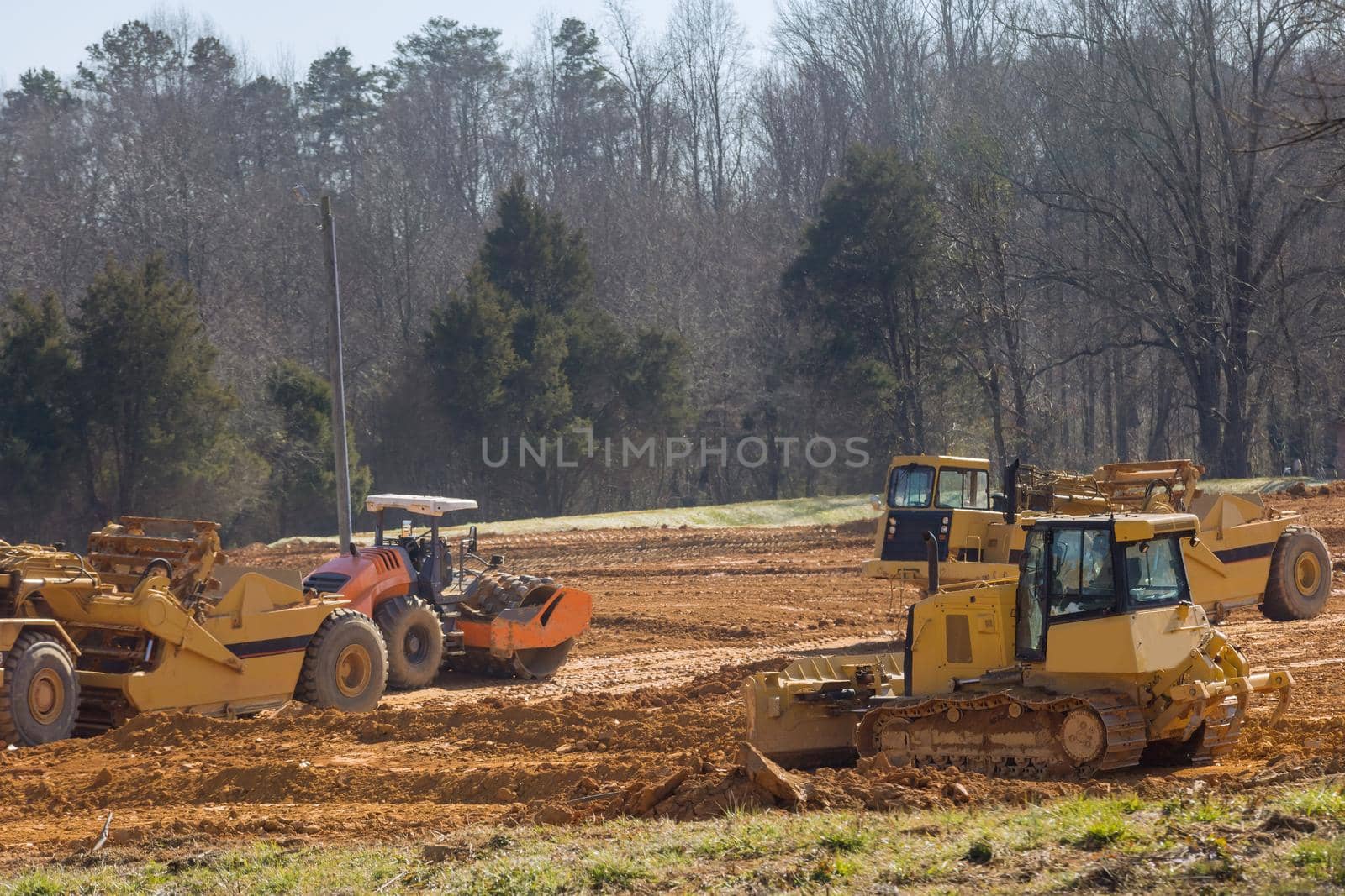 Excavator doing moving soil construction works landscaping works on construction by ungvar